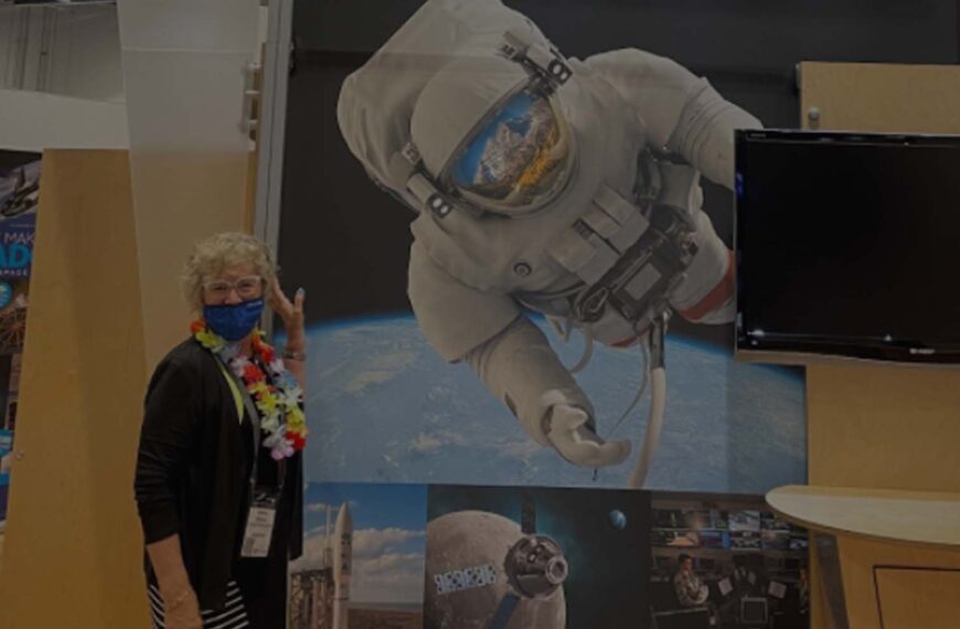 a woman with a booth at the space symposium event